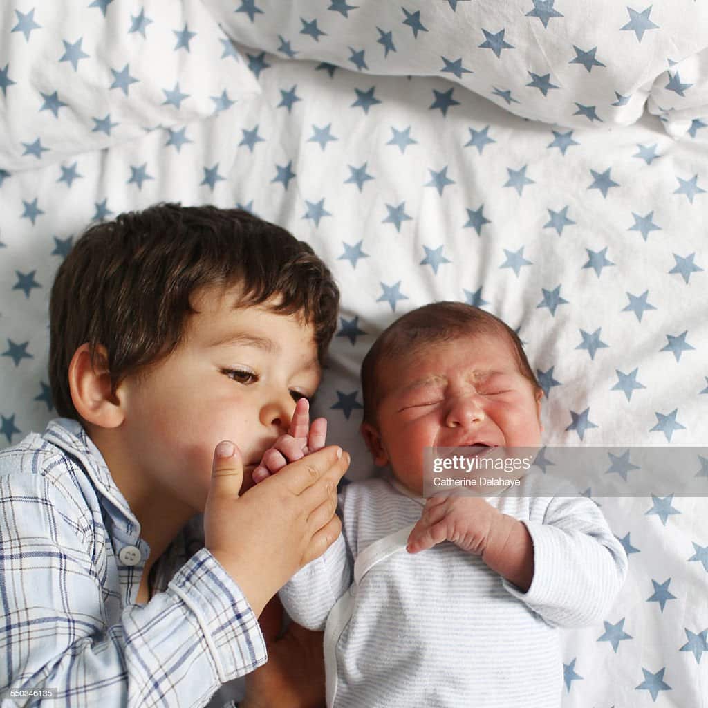 A Boy Taking Care Of His New Born Brother High